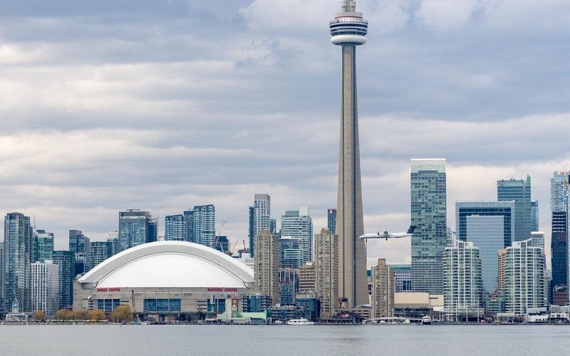 Toronto's waterfront skyline across the harbour, with the CN Tower and the Rogers Centre dome
